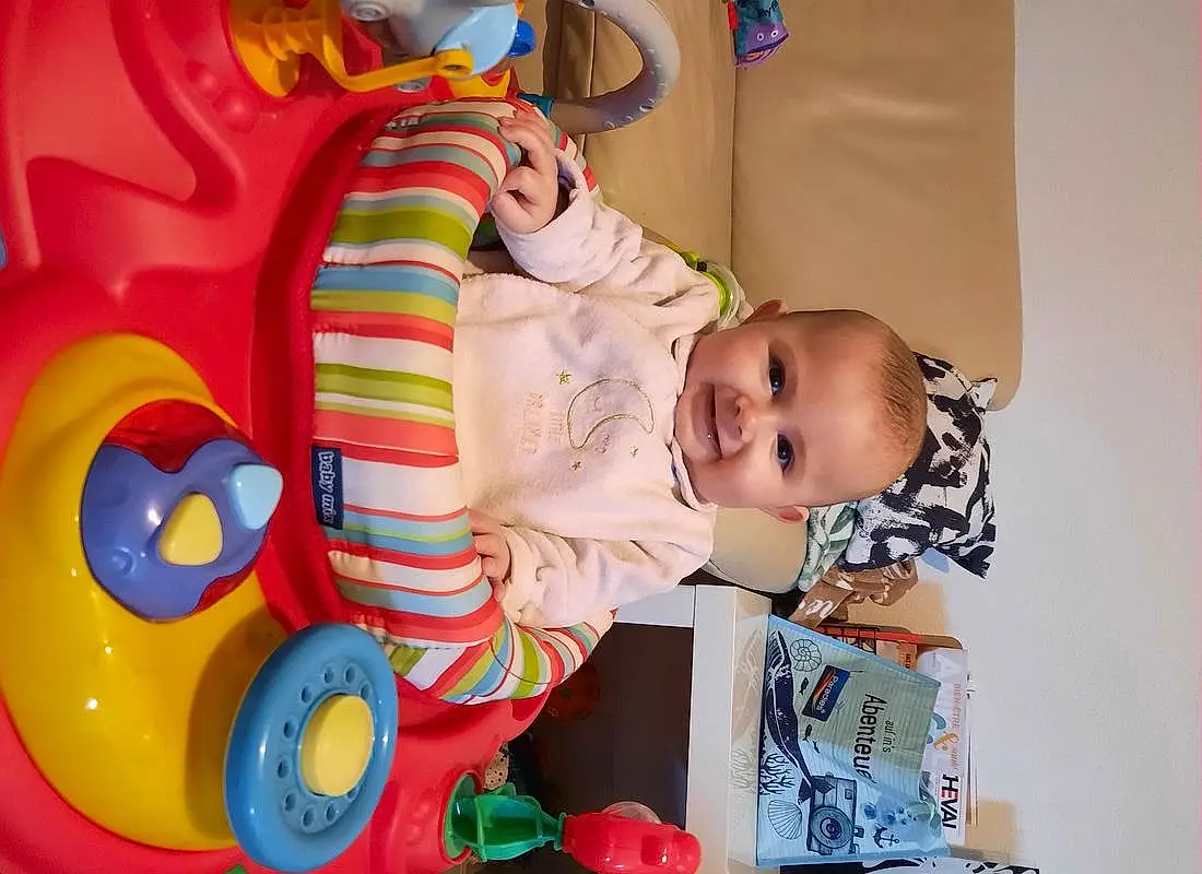 Facial Expression, Baby Playing With Toys, Jouets, Bambin, Baby, Baby & Toddler Clothing, Fun, People, Happy, Sourire, Enfant, Baby Products, Riding Toy, Play, Room, Baby Toys, Plastic, Assis, Toy Vehicle, Kindergarten, Personne, Joy