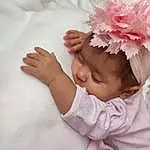 Hair, Joue, Peau, Head, Lip, Hand, Baby, Textile, Baby & Toddler Clothing, Sleeve, Gesture, Finger, Comfort, Rose, Petal, Bambin, Happy, Headgear, Headpiece, Nail, Personne