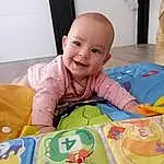 Joue, Sourire, Peau, Yeux, Tummy Time, Textile, Baby, Sleeve, Baby & Toddler Clothing, Rose, Bambin, Fun, Comfort, Happy, Baby Playing With Toys, Linens, Enfant, Baby Products, Personne, Joy