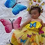 Bleu, Blanc, Mythical Creature, Dress, Textile, Baby & Toddler Clothing, Rose, Pollinator, Butterfly, Happy, Art, Bambin, Headpiece, Petal, Magenta, Doll, Fashion Design, Jouets, Moths And Butterflies, Fashion Accessory, Personne