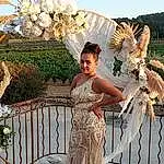 Ciel, Blanc, Plante, Lighting, Dress, Bridal Clothing, Gown, Happy, Faon, Fleur, Arecales, Arbre, Wedding Dress, Bridal Party Dress, Landscape, Fashion Design, Bridal Accessory, Formal Wear, Event, Waist, Personne