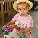 Nez, Joue, Peau, Head, Coiffure, Photograph, Yeux, Chapi Chapo, Facial Expression, Blanc, Sun Hat, Baby Playing With Toys, Iris, Yellow, Dress, Jouets, Happy, Personne